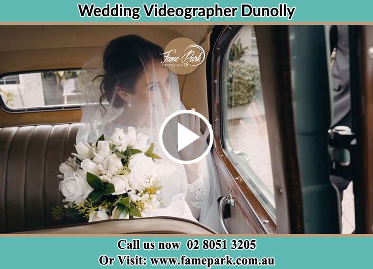 The Bride holding a bouquet of flowers inside the wedding car Dunolly NSW 2330